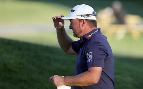 Graeme McDowell, of Northern Ireland, walks off the ninth green after completing the second round of the Genesis Open golf tournament at Riviera Country Club  - Credit: AP