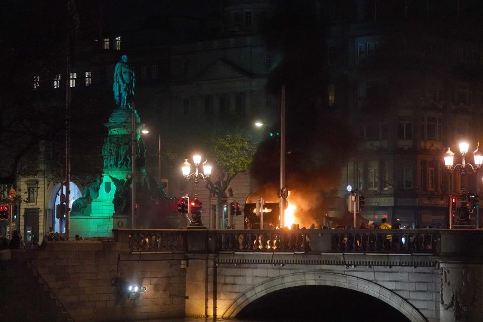 A bus on fire on O’Connell Street in Dublin (Brian Lawless/PA) (PA Wire)