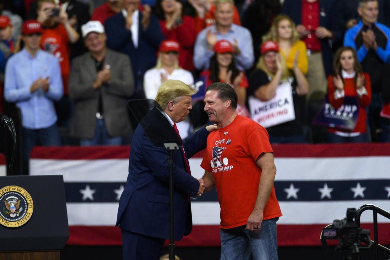 Lt Bob Kroll, head of the Minneapolis police union, shakes hands with Donald Trump during a rally at the Target Center in Minneapolis on 10 October, 2019: Getty
