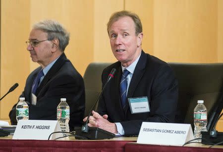 U.S. Securities and Exchange Commission (SEC) Director of Corporation Finance Keith Higgins (R) moderates a panel discussion at SEC headquarters in Washington November 20, 2014. REUTERS/Joshua Roberts