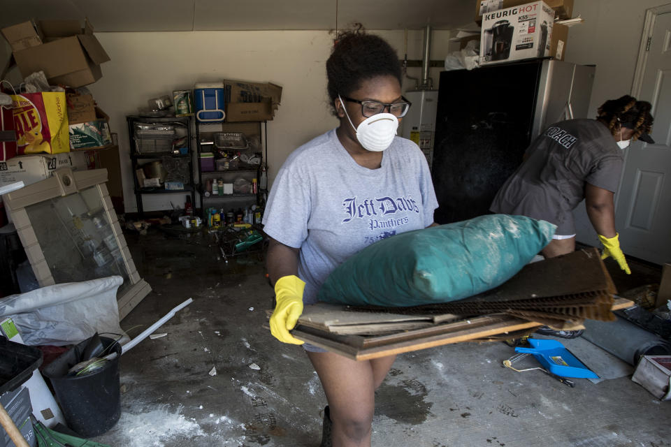 <p>Menion Brock and Michelle Green clean up their home, damaged by floodwaters of Tropical Storm Harvey, in the Parkway Forest subdivision of Houston, Thursday, Aug. 31, 2017. (Photo: Brett Coomer/Houston Chronicle via AP) </p>