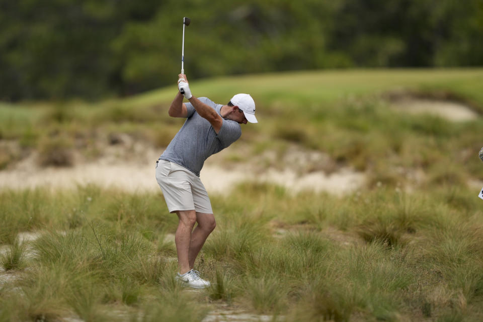 Rory McIlroy, of Northern Ireland, hits from the native area on the third hole during a practice round for the U.S. Open golf tournament Wednesday, June 12, 2024, in Pinehurst, N.C. (AP Photo/Matt York)