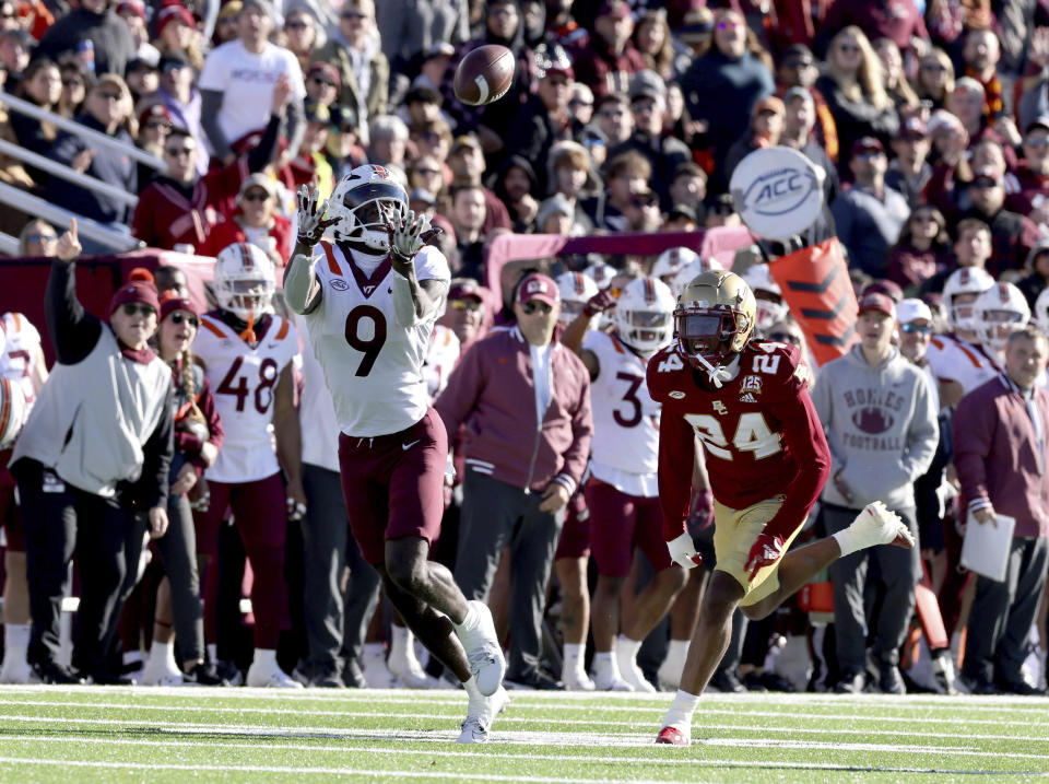 Virginia Tech wide receiver Da'Quan Felton (9) hauls in a pass while being pursued by Boston College cornerback Amari Jackson (24) during the first half of an NCAA college football game Saturday, Nov. 11, 2023 in Boston. (AP Photo/Mark Stockwell)