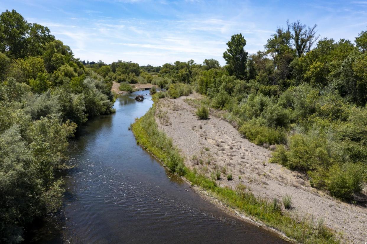 An exposed gravel bar stretches along the Russian River in Healdsburg, Calif., in June 2021.