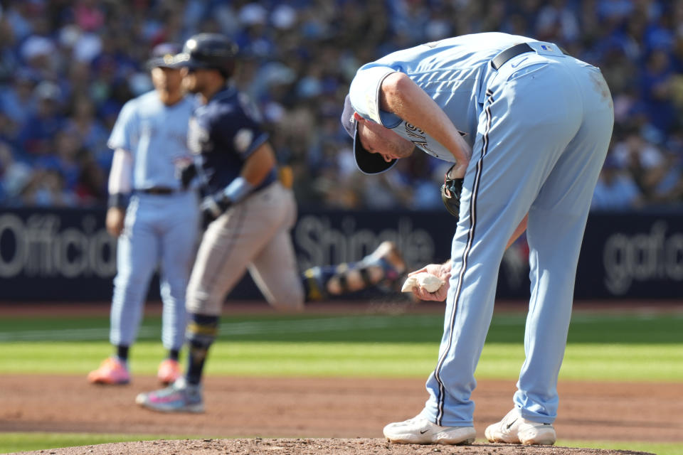 Toronto Blue Jays starting pitcher Wes Parsons, right, reacts as Tampa Bay Rays' Jonathan Aranda, center, rounds the bases after hitting a grand slam during second-inning baseball game action in Toronto, Sunday, Oct. 1, 2023. (Frank Gunn/The Canadian Press via AP)