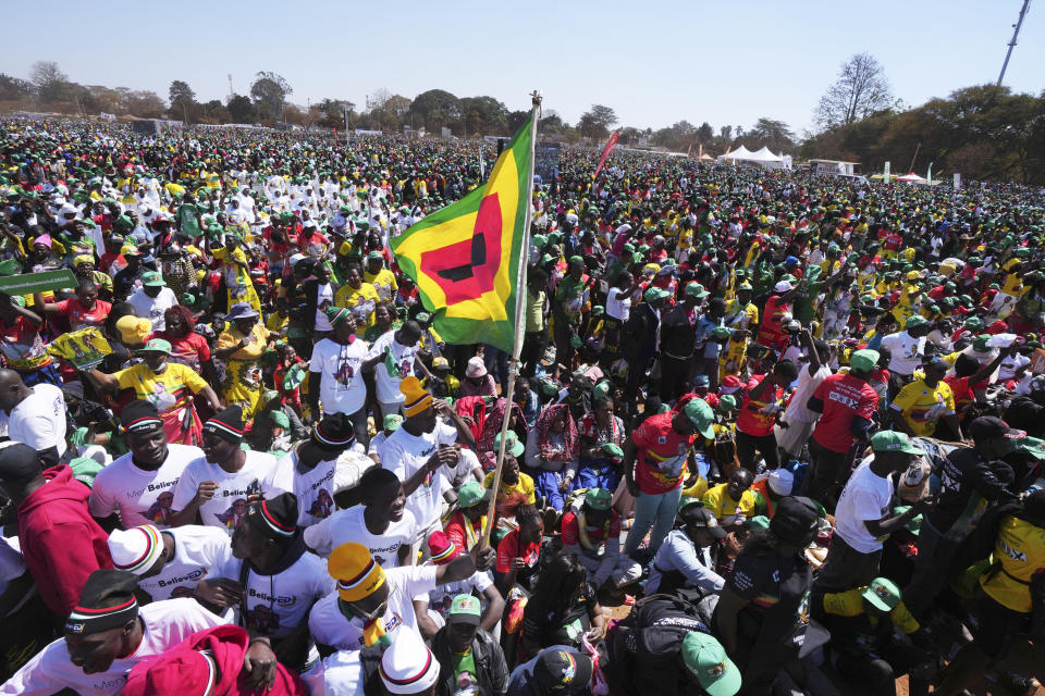 Supporters of Zimbabwean President Emmerson Mnangagwa are seen at a campaign rally in Harare, Wednesday, Aug. 9, 2023. Mnangagwa addressed thousands of supporters in a speech laden with calls for peace, days after his supporters were accused of stoning an opposition activist to death ahead of general elections set for Aug. 23. (AP Photo/Tsvangirayi Mukwazhi)