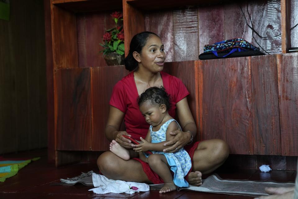 Fernanda de Araujo Moraes, president of the river dwellers' association speaks at her home in Lago Serrado community, near Carauari, Brazil, Thursday, Sept. 1, 2022. A Brazilian non-profit has created a new model for land ownership that welcomes both local people and scientists to collaborate in preserving the Amazon. To involve the riverine communities in governance, the institute set up a steering committee and launched a series of public meetings, called "community of dreams," that allow people to prioritize the improvements they want most. (AP Photo/Jorge Saenz)