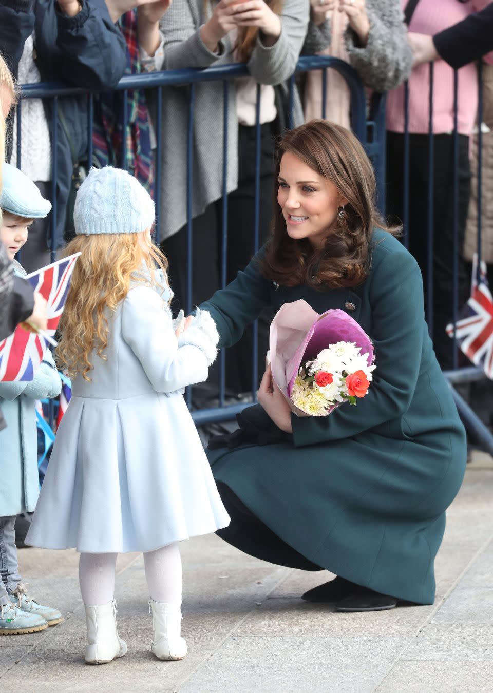 Despite her bump, Kate was seen crouching down to meet her littlest fans. Photo: Getty