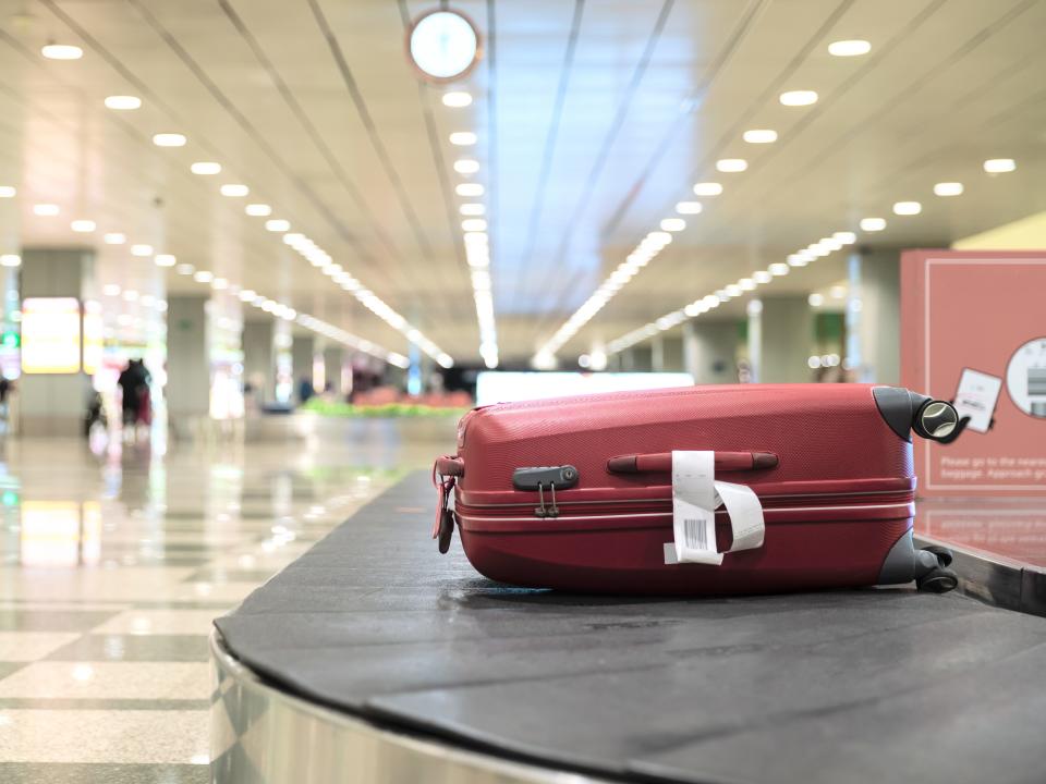 A suitcase on a baggage arrival belt.