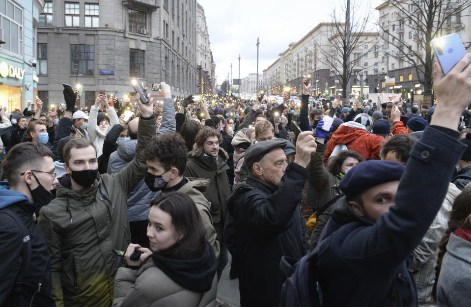 People light their cell phones during a protest in support of jailed opposition leader Alexei Navalny in Moscow, Russia, Wednesday, April 21, 2021. Human rights groups say police across Russia have arrested more than 180 people in connection with demonstrations supporting imprisoned opposition leader Alexei Navalny. Many were seized before protests even began, including two top Navalny associates in Moscow. (AP Photo/Denis Kaminev)