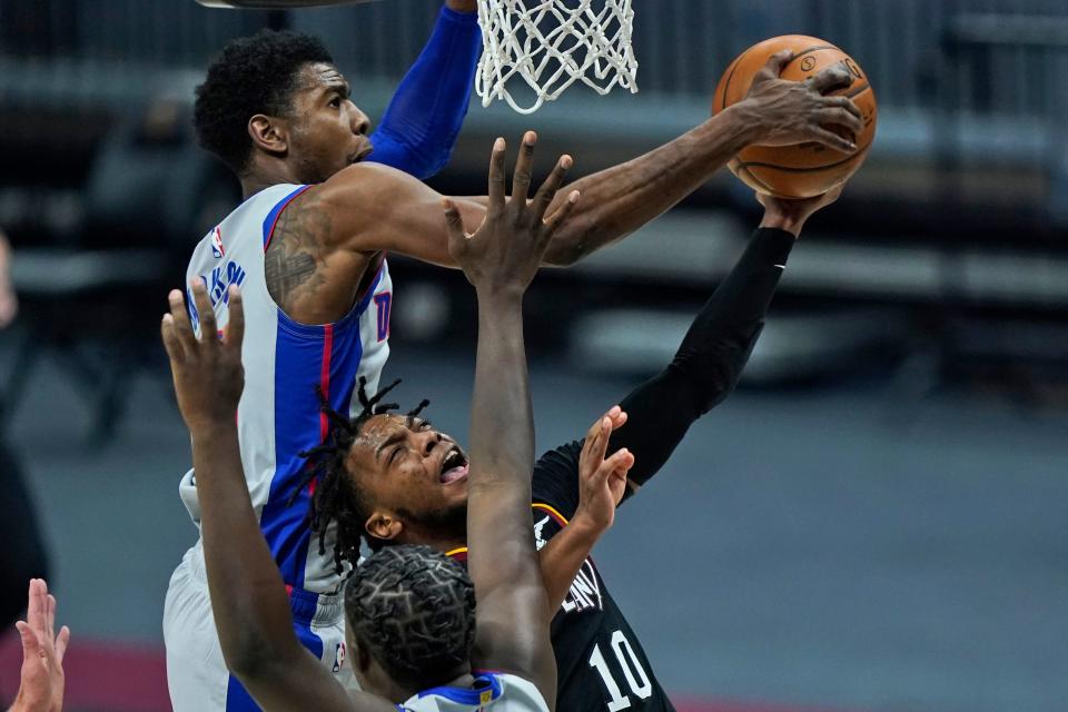 Cleveland Cavaliers' Darius Garland (10) drives to the basket as Detroit Pistons' Josh Jackson (20) knocks the ball loose in the first half of an NBA basketball game, Wednesday, Jan. 27, 2021, in Cleveland.