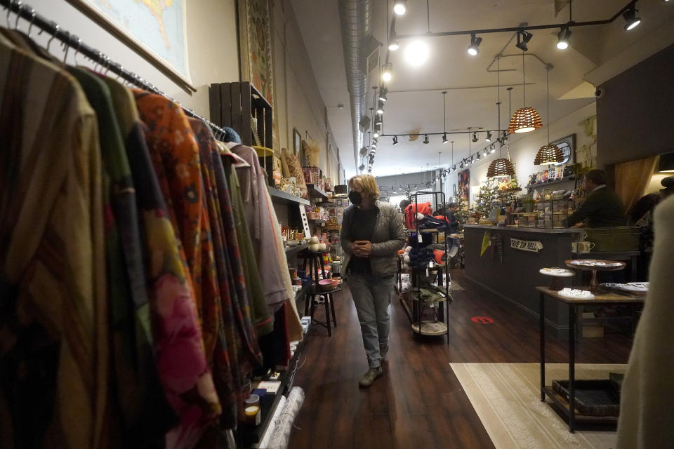 A customer shops at a Nathan & Co. store in Oakland, Calif., Monday, Dec. 12, 2022. Small retailers say this year looks much different than the last "normal" pre-pandemic holiday shopping season of 2019. They're facing decades-high inflation forcing them to raise prices and making shoppers rein in the freewheeling spending seen in 2021 when they were flush with pandemic aid and eager to spend. (AP Photo/Jeff Chiu)