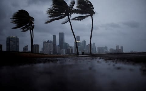 Dark clouds are seen over Miami's skyline before the arrival of Hurricane Irma - Credit: Carlos Barria/Reuters