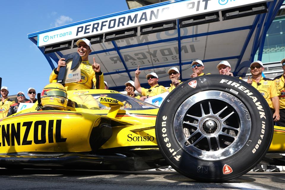 Scott McLaughlin, front, of New Zealand, celebrates after winning the pole for the Indianapolis 500 auto race at Indianapolis Motor Speedway, Sunday, May 19, 2024, in Indianapolis. (AP Photo/Darron Cummings)