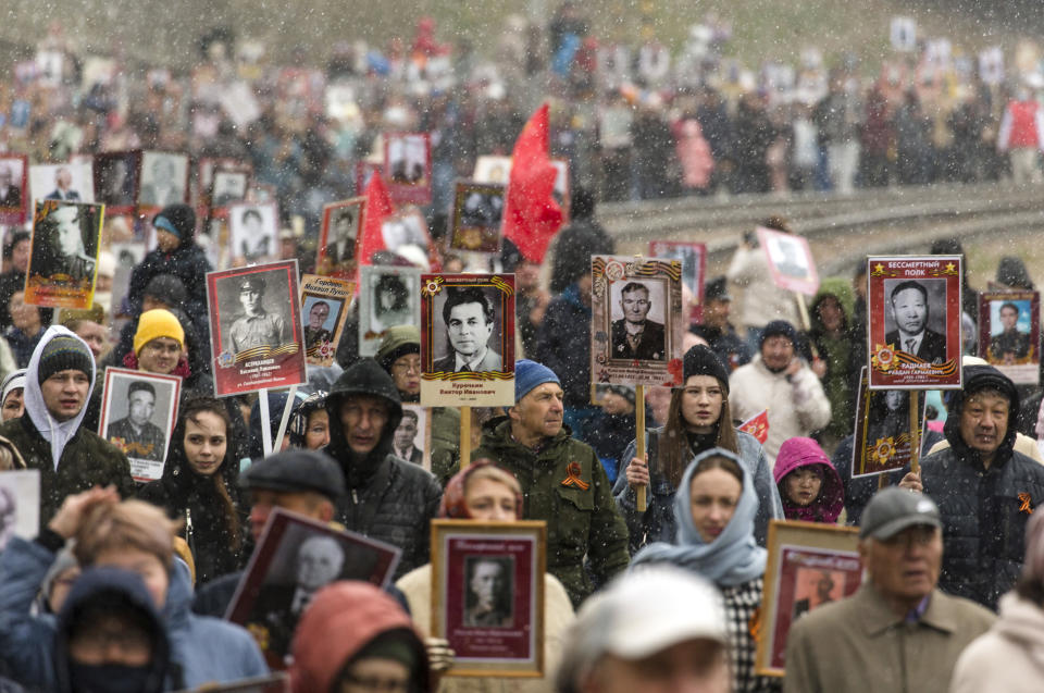 People carry portraits of relatives who fought in World War II, during the Immortal Regiment march in Ulan-Ude, the regional capital of Buryatia, a region near the Russia-Mongolia border, Russia, Monday, May 9, 2022, marking the 77th anniversary of the end of World War II. (AP Photo)