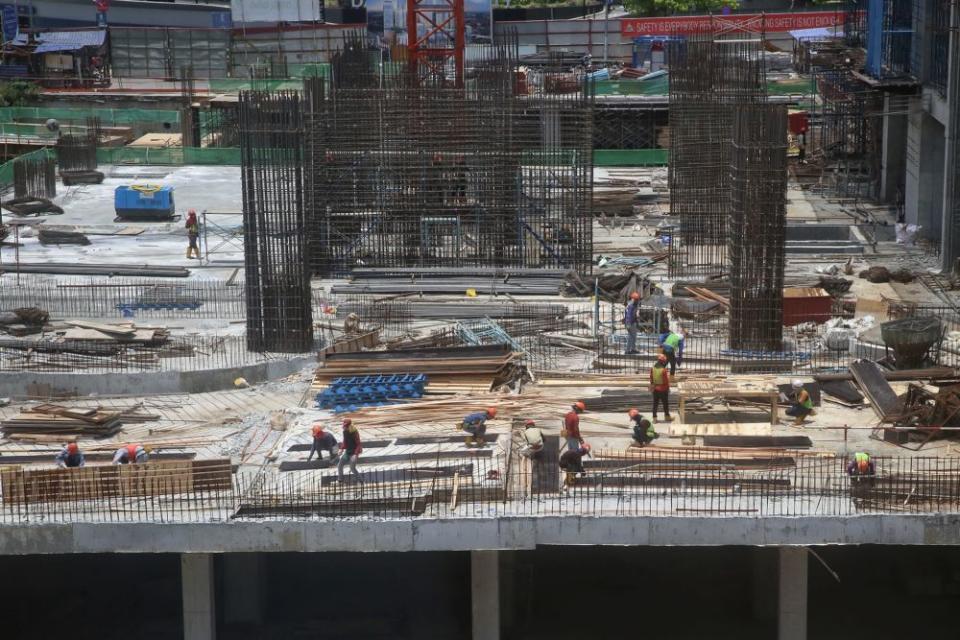 Workers are pictured at the construction site of Pavilion Damansara Heights March 18, 2020. — Picture by Choo Choy May