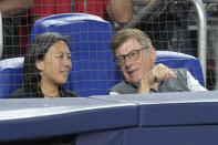 Bruce Sherman, right, Miami Marlins chairman and principal owner chats with Kim Ng, Marlins general manager, as they watch during the fourth inning of a baseball game against the Cincinnati Reds, Saturday, May 13, 2023, in Miami. (AP Photo/Wilfredo Lee)