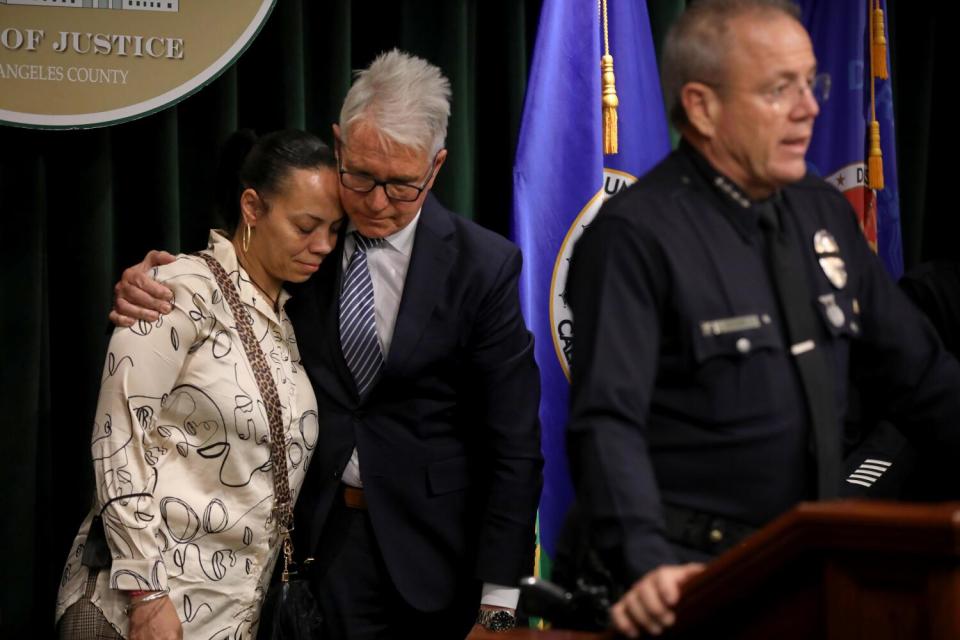 Los Angeles County District Attorney George Gascon comforts Eddrinna Cunningham, mother of LAPD Officer Darrell Cunningham