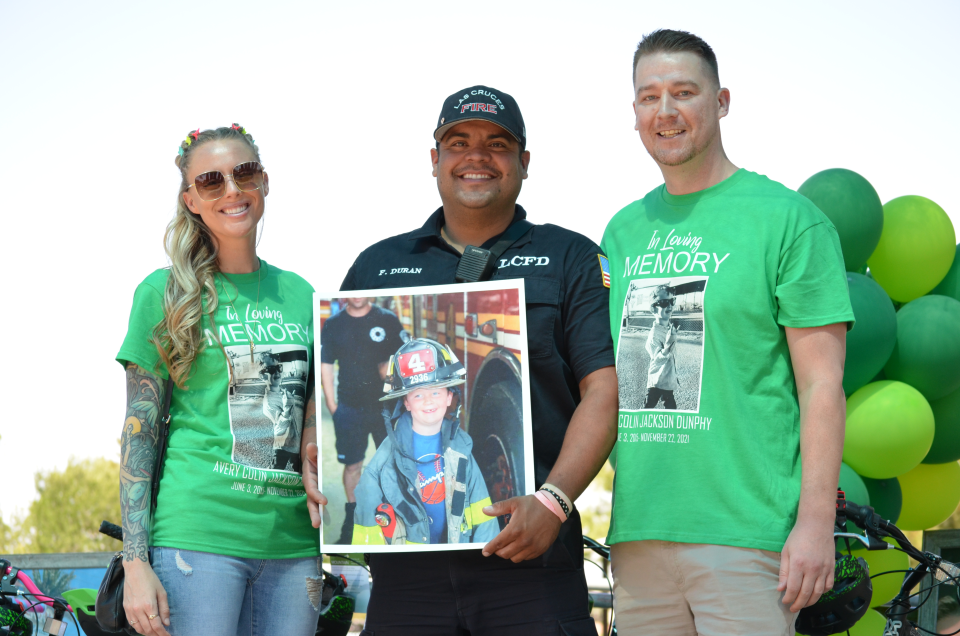 Patrick and Joanna Dunphy pose with Las Cruces firefighter Frankie Duran Friday, June 3, 2022 at Young Park where friends and family of Avery Jackson-Dunphy celebrated what would have been his seventh birthday.