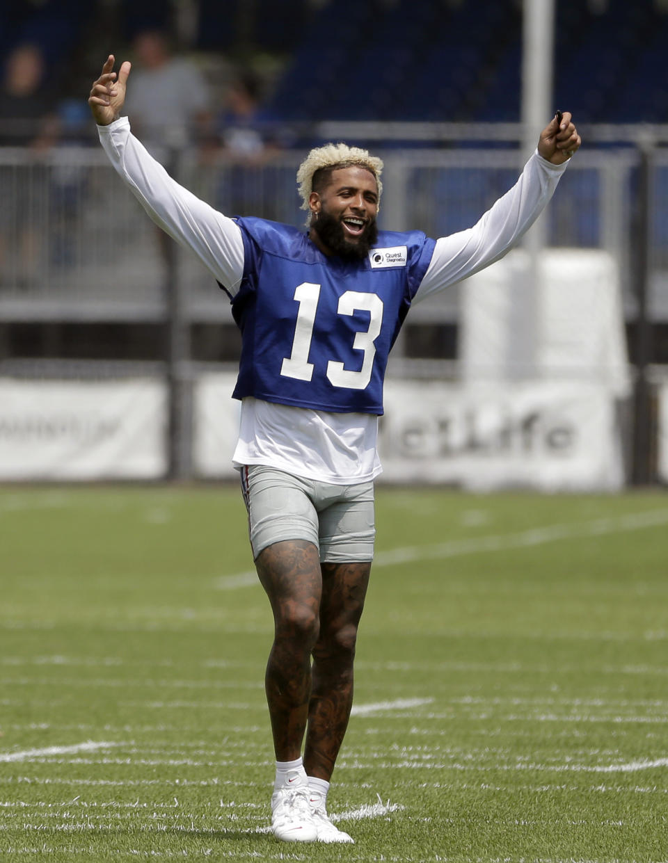 FILE - In this Aug. 7, 2018, file photo, New York Giants' Odell Beckham Jr. gestures after a practice at the NFL football team's training camp in East Rutherford, N.J. Beckham Jr. is now the NFL’s highest-paid wide receiver. A person familiar with the negotiations told The Associated Press Monday, Aug. 27, 2018, the team agreed to a five-year contract extension with the three-time Pro Bowler. The person spoke on condition of anonymity because the Giants have not announced the deal, which comes less than two weeks before the season opener against Jacksonville. (AP Photo/Seth Wenig, File)