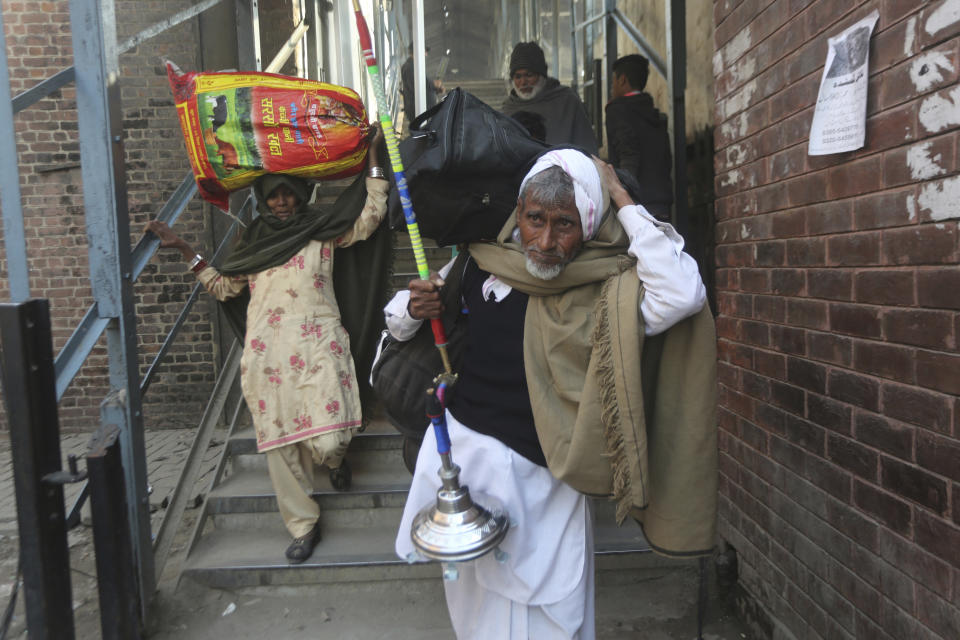 Indian passengers arrive at Lahore railway station to travel to India, in Pakistan, Thursday, Feb. 28, 2019. The Pakistan government temporally suspended the Pakistan-Indian bound Samjhuta Express after escalation tensions between the nuclear-armed rivals. (AP Photo/K.M. Chaudary)