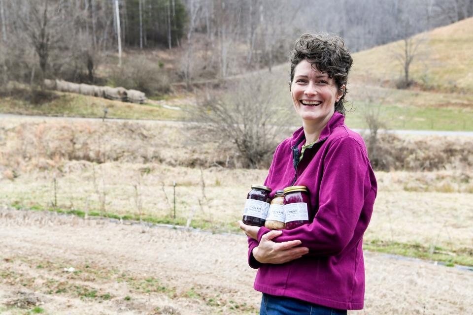 Meg Chamberlain holds jars of her fermented produce next to her field in Marshall, N.C., on Feb. 26.