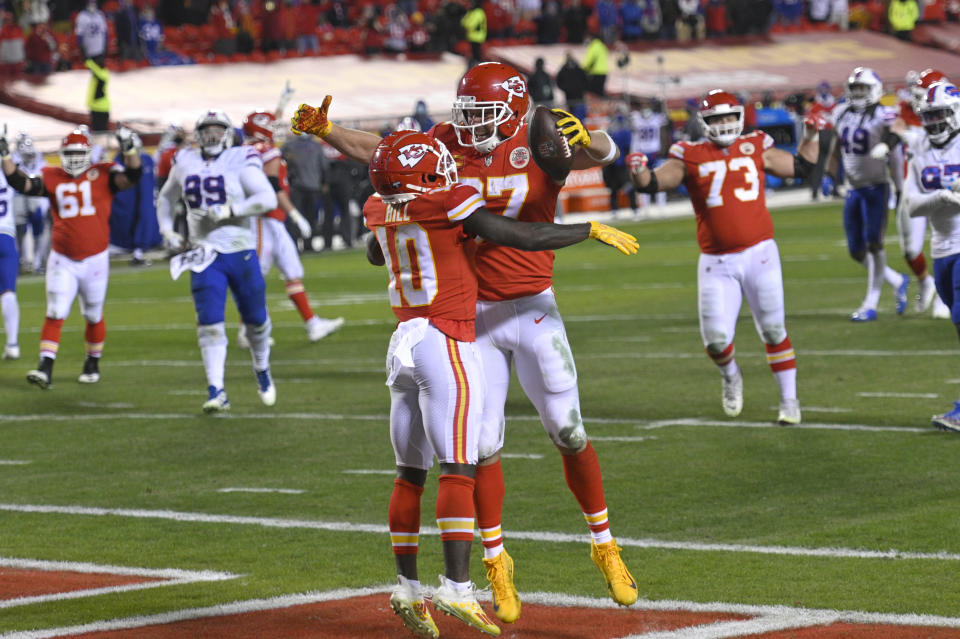 Kansas City Chiefs tight end Travis Kelce celebrates with teammate Tyreek Hill (10) after catching a 5-yard touchdown pass during the second half of the AFC championship NFL football game against the Buffalo Bills, Sunday, Jan. 24, 2021, in Kansas City, Mo. (AP Photo/Reed Hoffmann)