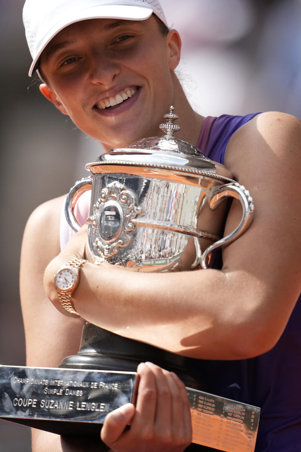 Poland's Iga Swiatek celebrates with the trophy as she won the women's final of the French Open tennis tournament against Italy's Jasmine Paolini at the Roland Garros stadium in Paris, France, Saturday, June 8, 2024. (AP Photo/Christophe Ena)