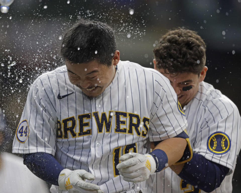 Milwaukee Brewers Keston Hiura is showered with water after hitting a sacrifice fly to win the game against the Colorado Rockies during the 11th inning of a baseball game Friday, June 25, 2021, in Milwaukee. (AP Photo/Jeffrey Phelps)