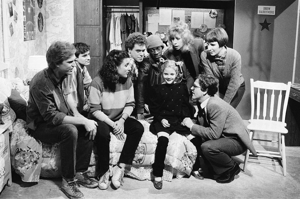 Drew Barrymore doing a skit for SNL, with the cast surrounding her