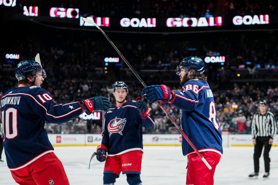 Nov 1, 2023; Columbus, Ohio, USA; Columbus Blue Jackets left wing Kirill Marchenko (86) celebrates a goal with left wing Dmitri Voronkov (10) and defenseman Jake Bean (22) during the first period of the NHL hockey game against the Tampa Bay Lightning at Nationwide Arena.