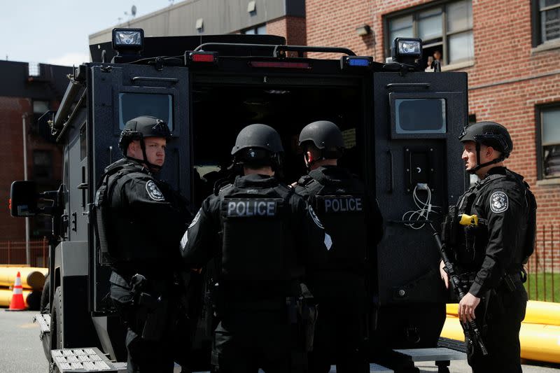 Law enforcement officers stand near the place where the shooter barricaded himself, after a shooting at a Stop and Shop grocery store, in Hempstead