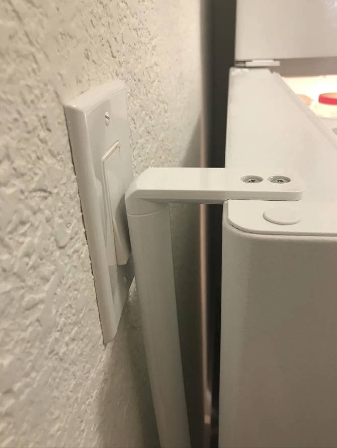 The refrigerator door hits the light switch