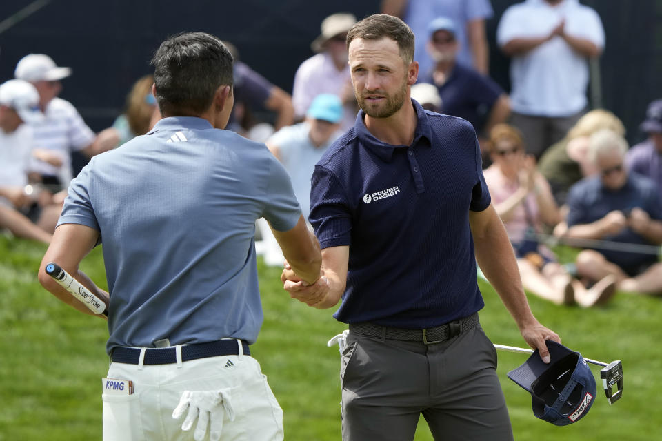 Wyndham Clark, right, shakes hands with Collin Morikawa after finishing their round during the second round of The Players Championship golf tournament Friday, March 15, 2024, in Ponte Vedra Beach, Fla. (AP Photo/Lynne Sladky)