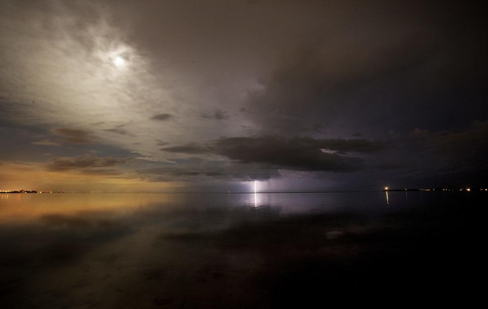 A lone lightning bolt strikes off of the Sanibel Causeway on July 15, 2019. It is the season as lightning storms pass through the area. 