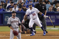 Los Angeles Dodgers' Albert Pujols, second from right, hits a solo home run as Arizona Diamondbacks relief pitcher Alex Young, left, and catcher Bryan Holaday, second from left, watch along with home plate umpire Tony Randazzo during the seventh inning of a baseball game Saturday, July 10, 2021, in Los Angeles. (AP Photo/Mark J. Terrill)