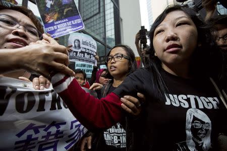 Erwiana Sulistyaningsih (R), a former Indonesian domestic helper, is greeted by her supporters outside a district court in Hong Kong February 27, 2015. REUTERS/Tyrone Siu