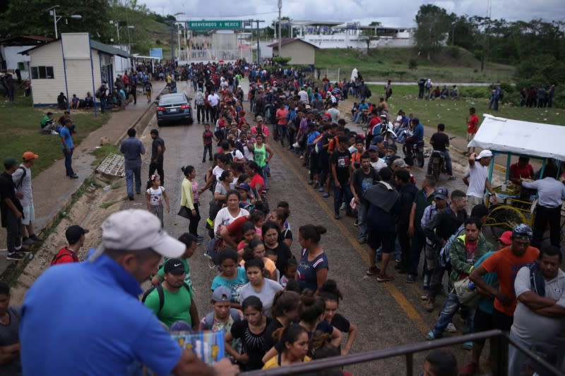 Migrants from Central American, part of a caravan travelling to the U.S., arrive at the border between Guatemala and Mexico, in El Ceibo