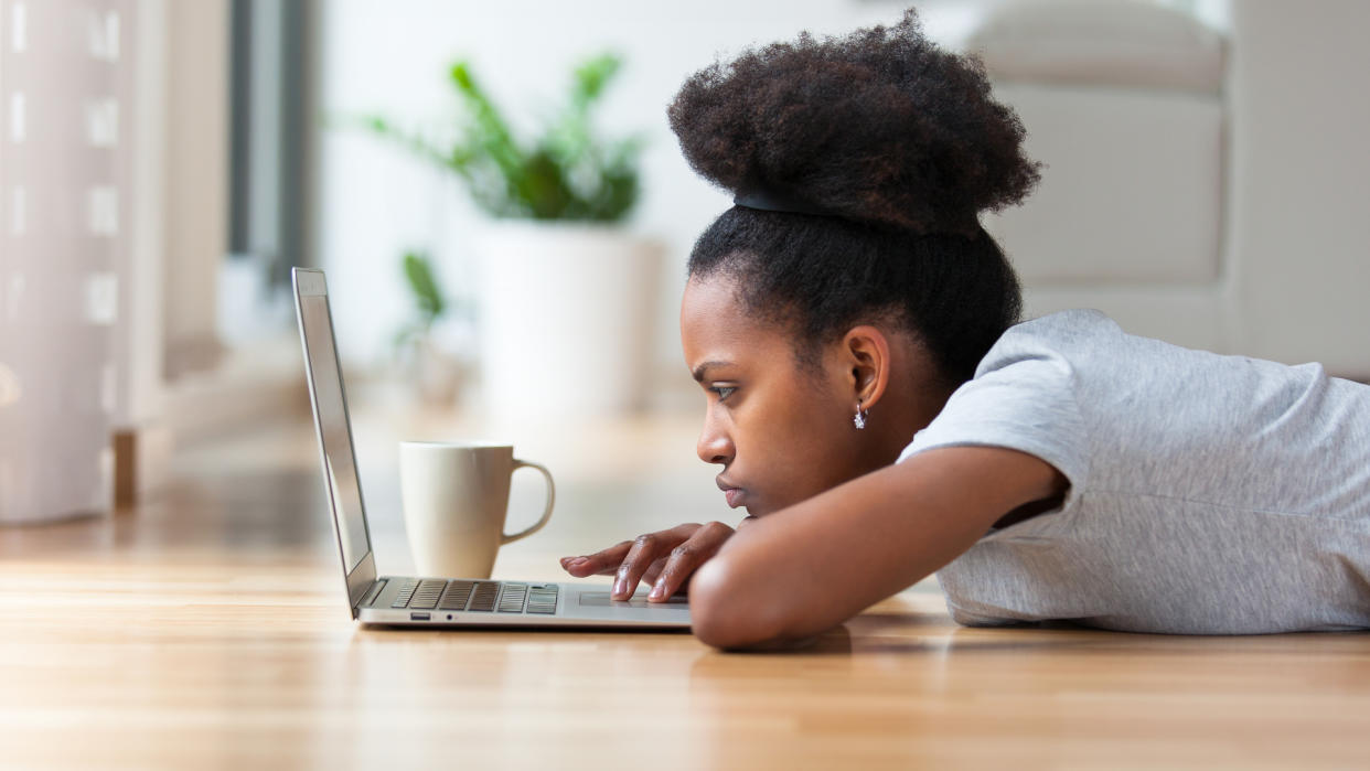 African American woman using a laptop in her living room