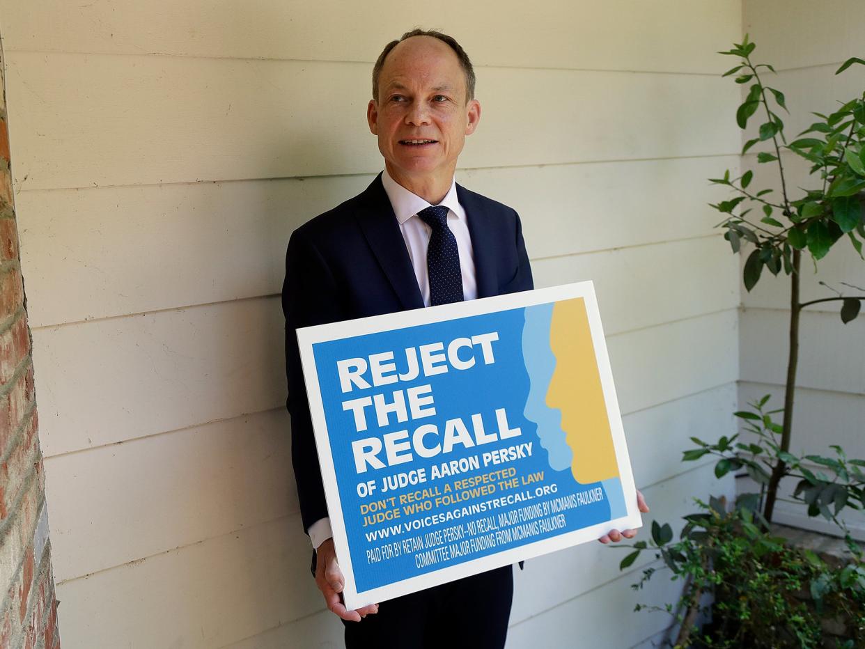 Judge Aaron Persky poses for a photo with a sign opposing his recall in Los Altos Hills, California: AP