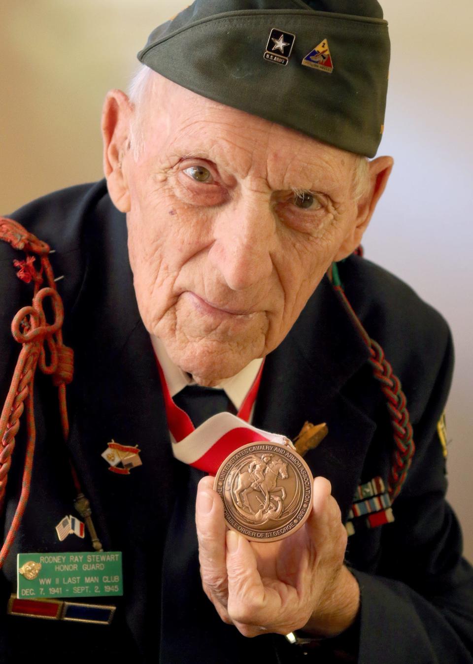 WWII veteran Ray Stewart, who drove a tank in the Battle of the Bulge, shows off his Order of St. George medal from the U.S. Cavalry and Armor Association in 2016.