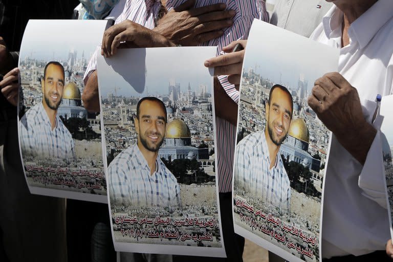 Protesters in Jerusalem hold portraits of Samer Issawi, a Palestinian prisoner on hunger strike, on September 18, 2012. The deteriorating health of prisoners on hunger strike in Israeli jails has sparked several mass protests across the Palestinian territories, some of which resulted in clashes with the army
