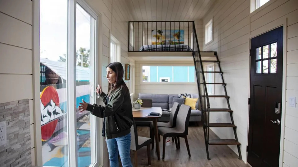 Developer Hannah Ball opens the back door of a tiny home she had on display in Garden City in 2021.