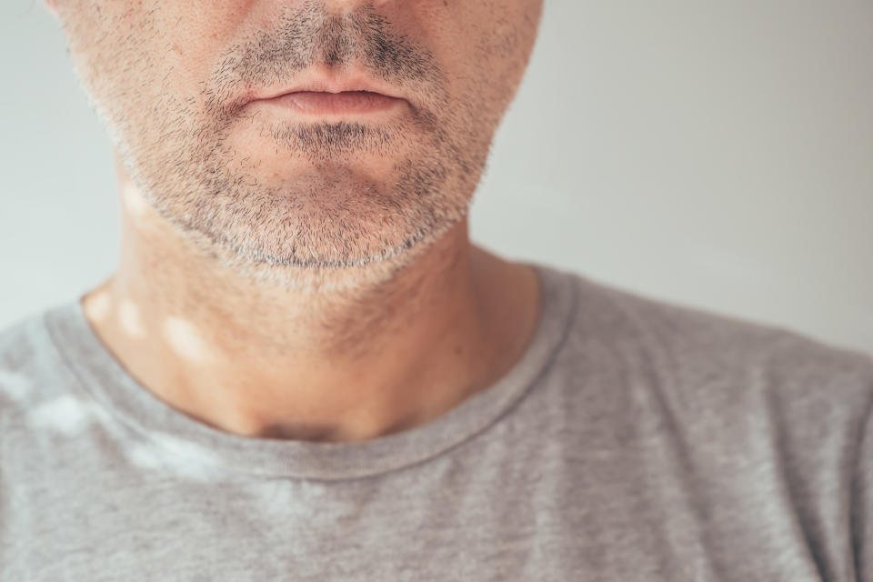 Male chin and jawline, closeup of unshaven man's face, selective focus double chin