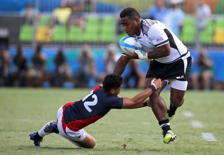 2016 Rio Olympics - Rugby - Men's Semifinals - Fiji v Japan - Deodoro Stadium - Rio de Janeiro, Brazil - 11/08/2016. Josua Tuisova (FIJ) of Fiji runs in for a try as Kazuhiro Goya (JPN) of Japan tackles. REUTERS/Alessandro Bianchi