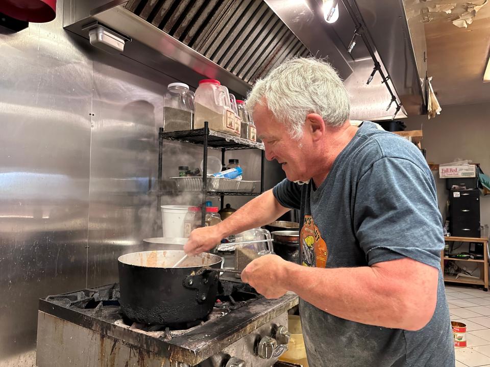 Rom's Takeout/Giovanello's Italian Market owner and chef David Roscioli prepares sauce on his next to last day on the job Friday. Roscioli is closing the popular Sturbridge takeout restaurant for good Saturday.