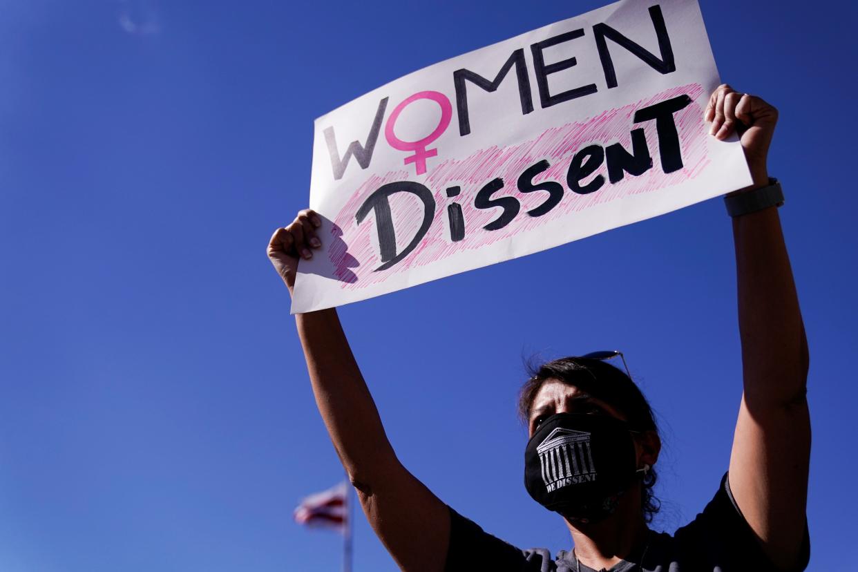 A woman holding up a sign that says "Women dissent" Erin Scott/Reuters