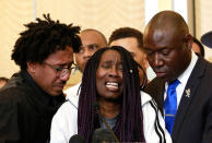 <p>A tearful Sequita Thompson, center, discusses the shooting of her grandson, Stephon Clark, during a news conference, Monday, March 26, 2018, in Sacramento, Calif. Clark, who was unarmed, was shot and killed by Sacramento police officers who were responding to a call about person smashing car windows a week ago. Thompson was accompanied by Clark’s uncle, Curtis Gordon, left, and attorney Ben Crump, right. (Photo: Rich Pedroncelli/AP) </p>