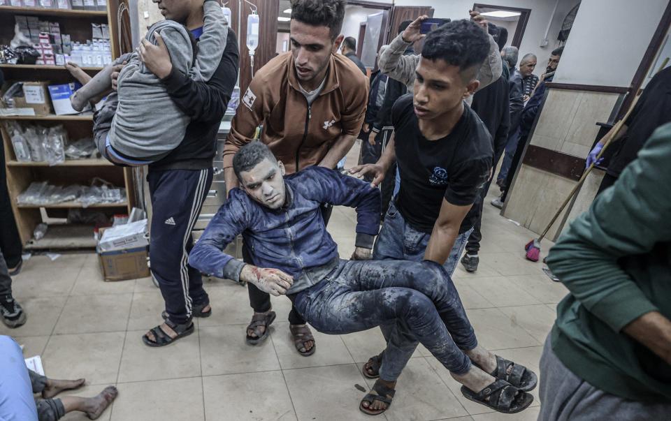 Injured Palestinians are brought to Deir al Balah's Aksa hospital from the Al-Maghazi refugee camp after an Israeli strike