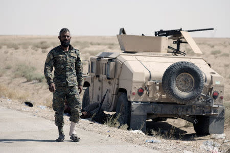 A fighter of Syrian Democratic Forces (SDF) is seen in the eastern part of Deir al Zor, Syria September 12, 2017. REUTERS/Rodi Said